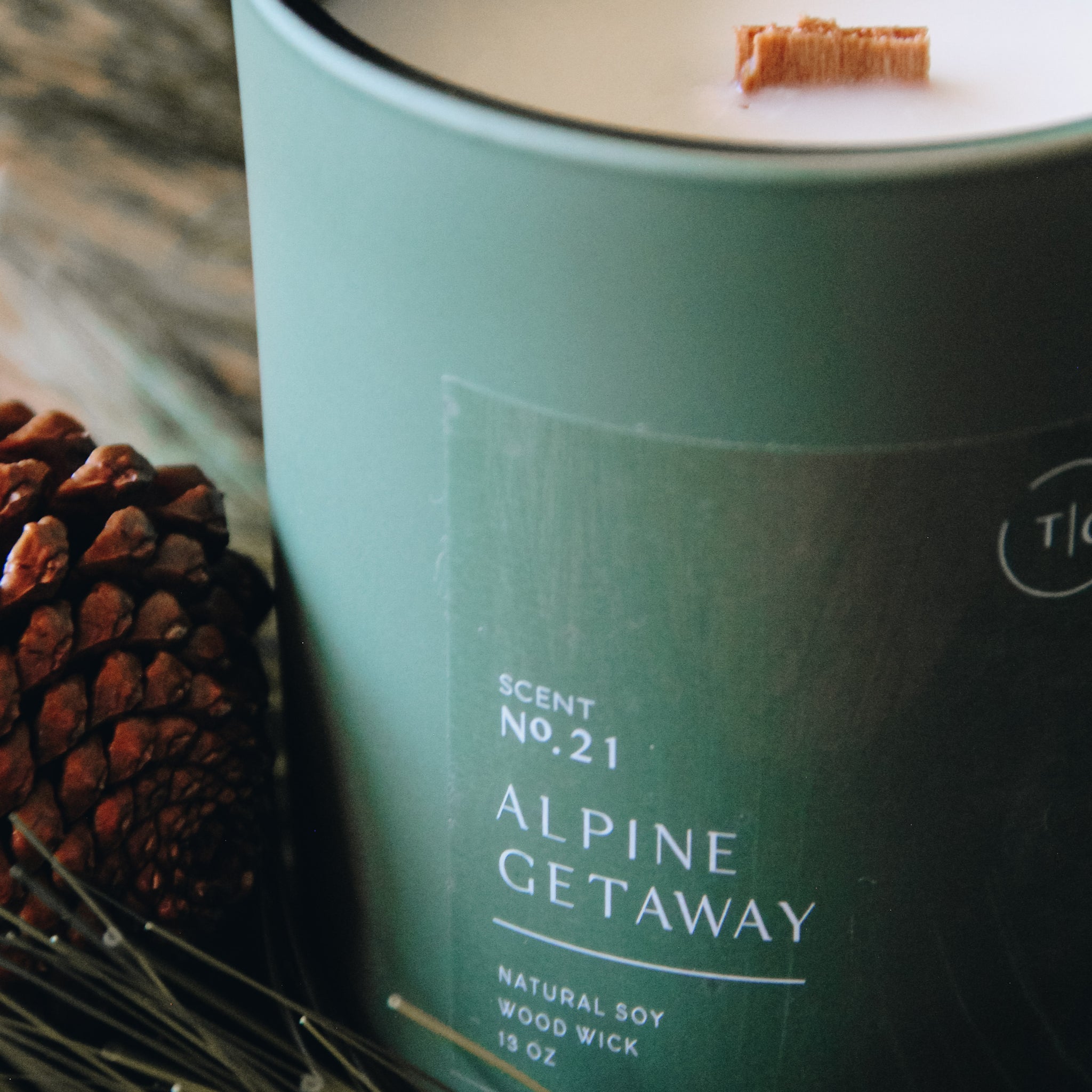 The Chandlerie's Alpine Getaway - a soy wax, wood wick candle in green glass vessel