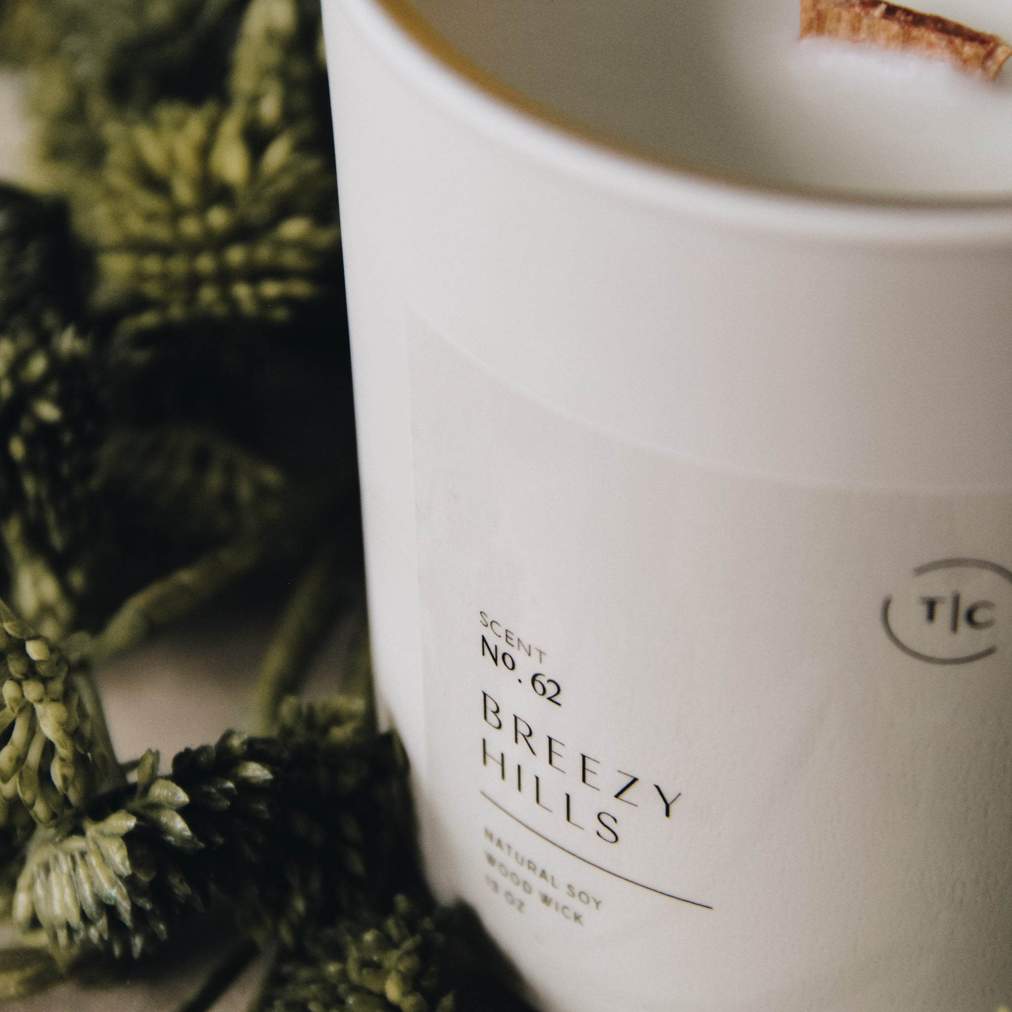 The Chandlerie's Breezy Hills - a soy wax, wood wick candle in cream glass vessel